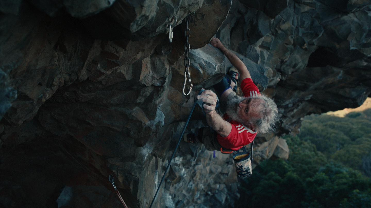 Still image of 72-year-old climber Ian Elliott on mountain